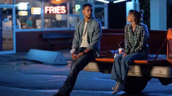 Ledger Ward (Tyriq Withers) and Kenna Rowan (Maika Monroe) sit on a pickup at night