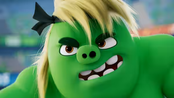 A green pig with blond hair and a black bow glares against a blurred background