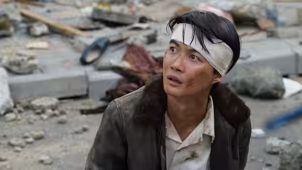 Koichi Shikishima (Ryunosuke Kamiki) with bandaged head amid rubble