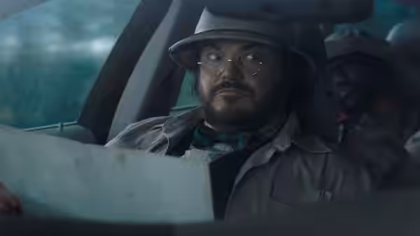 Professor Sheldon Oberon (Jack Black) studies a map inside a vehicle