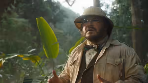 Professor Sheldon Oberon (Jack Black) gestures amid dense jungle foliage