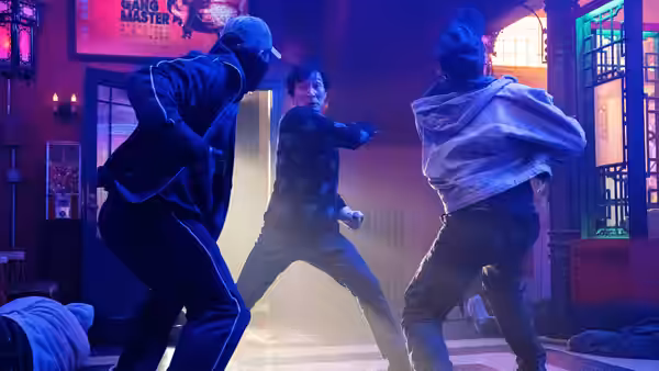 Marvin Gable (Ke Huy Quan) fights two attackers inside a neon-lit room
