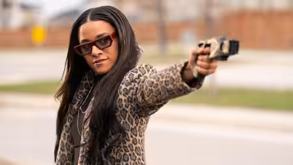 Rose Carlisle (Ariana DeBose) aims a handgun outdoors
