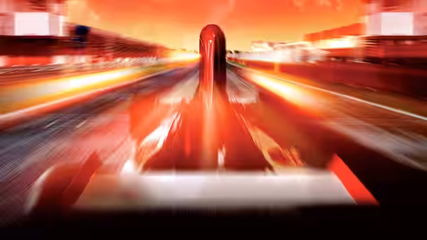 View from inside a red racing car speeding on a track at sunset