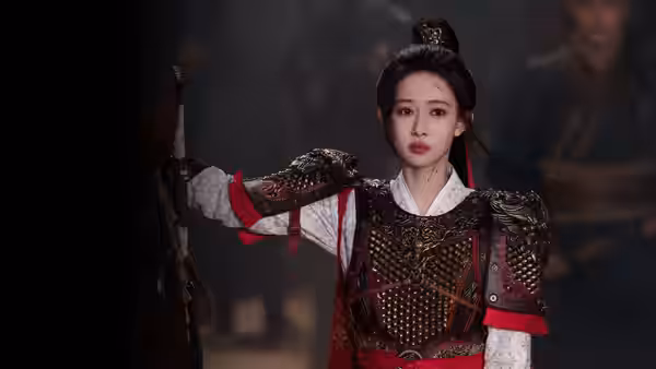 Mu Wanyao (Meng Ziyi) stands in ornate armor, holding a weapon in a dim palace hall