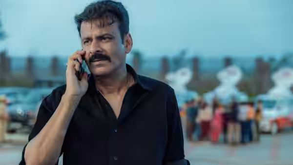 Ajay Dixit (Manoj Bajpai) speaks on his phone outside a crowded venue