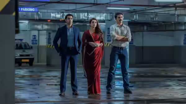 Three people stand together in an underground parking garage