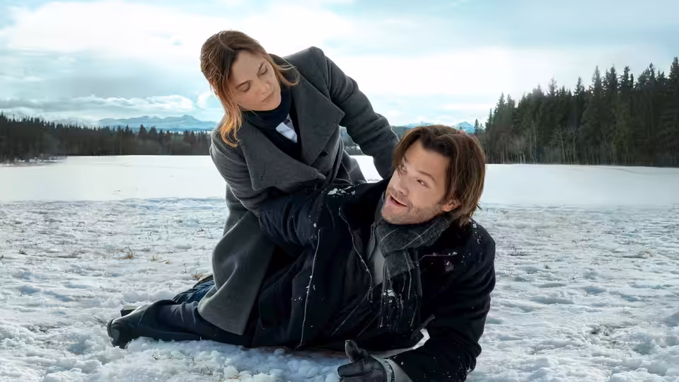 Hannah (Leighton Meester) leans over Jack (Jared Padalecki) on a frozen lake