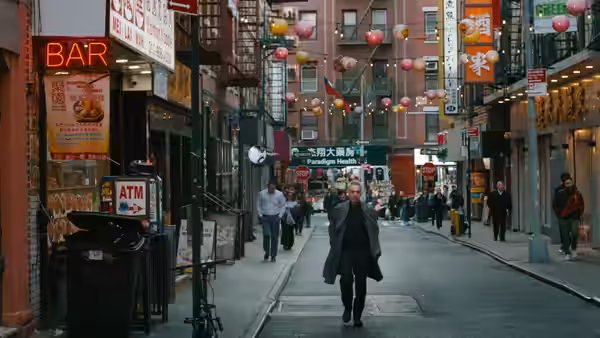 Harry (John Turturro) walks down a lantern-strung city street