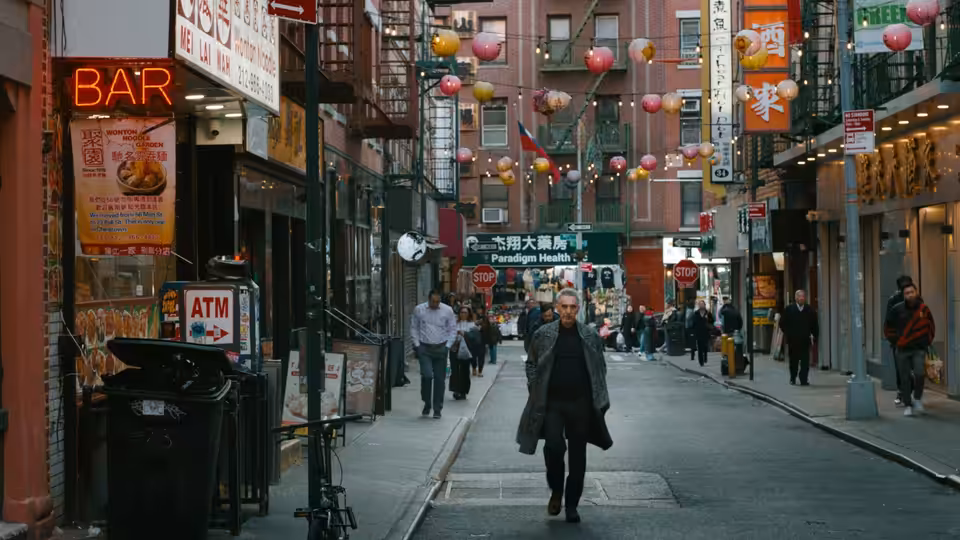 Harry (John Turturro) walks down a lantern-strung city street