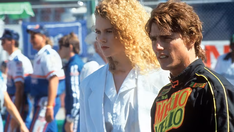 Dr. Claire Lewicki (Nicole Kidman) and Cole Trickle (Tom Cruise) standing together at the track