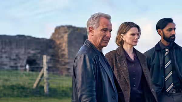 Joe Ruby (Robson Green), DI Rose O'Connell (Liz White) and DS Raj Singh beside a ruined castle