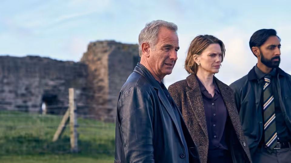 Joe Ruby (Robson Green), DI Rose O'Connell (Liz White) and DS Raj Singh beside a ruined castle