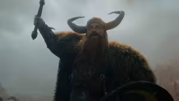 Stoick (Gerard Butler) raises a mace in a misty rocky area
