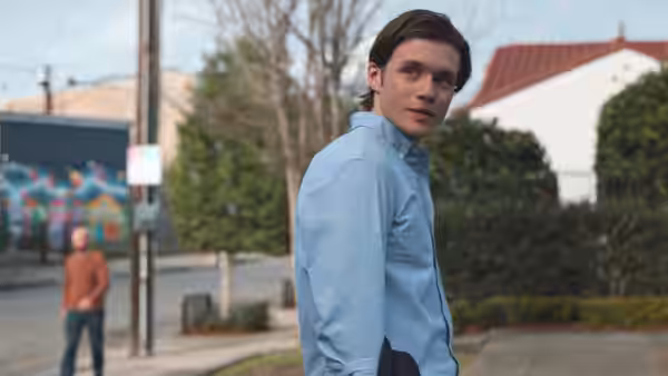 Charlie (Nick Robinson) looks back over his shoulder on a suburban sidewalk
