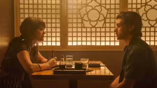 Harper (Emilia Jones) and Charlie (Nick Robinson) sit facing each other across a restaurant table