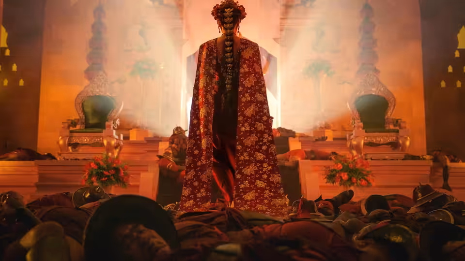 A robed figure stands amid fallen bodies before twin thrones in a smoky hall