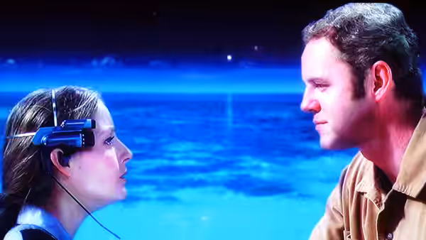 Ellie Arroway (Jodie Foster) wearing a neural headset faces Palmer Joss (Matthew McConaughey)