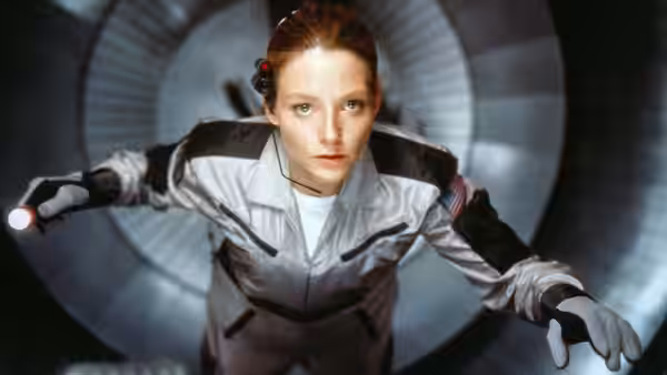 Ellie Arroway (Jodie Foster) in a spacesuit floating inside a circular tunnel