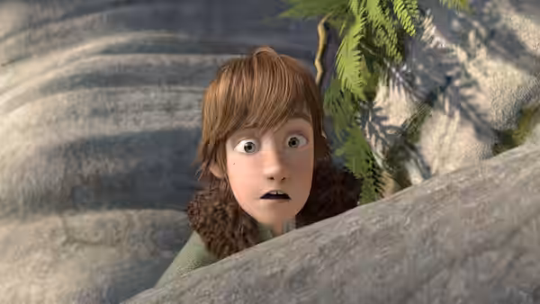 Hiccup (Jay Baruchel) peeking over a rock with wide eyes