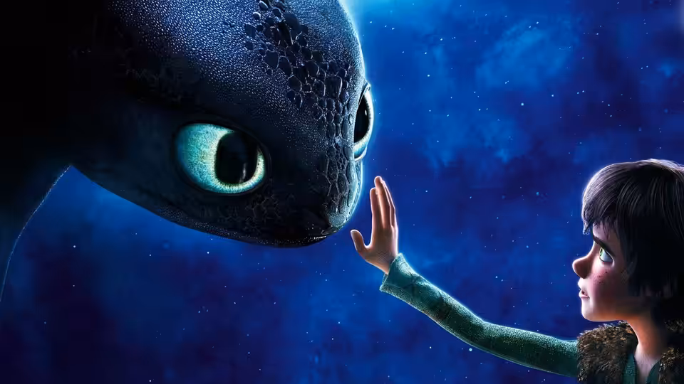 Hiccup (Jay Baruchel) reaching toward Toothless under a starry sky