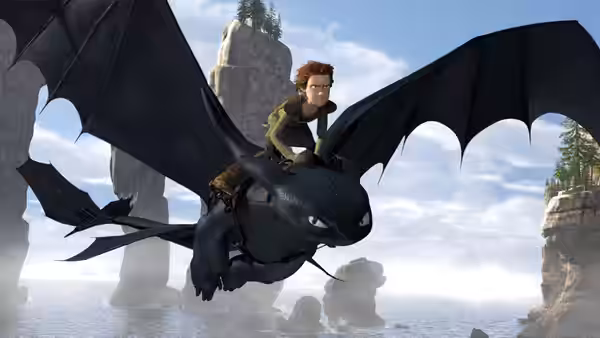 Hiccup (Jay Baruchel) riding Toothless over the ocean near cliffs