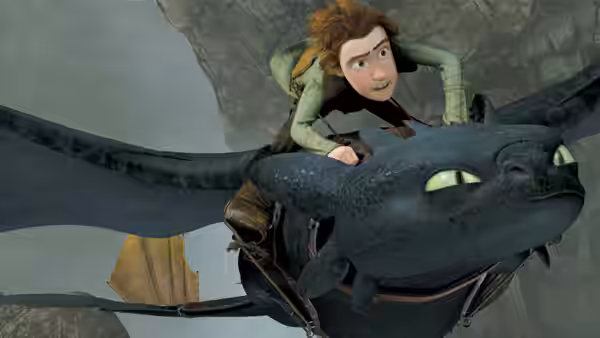 Hiccup (Jay Baruchel) flying on Toothless through a rocky canyon