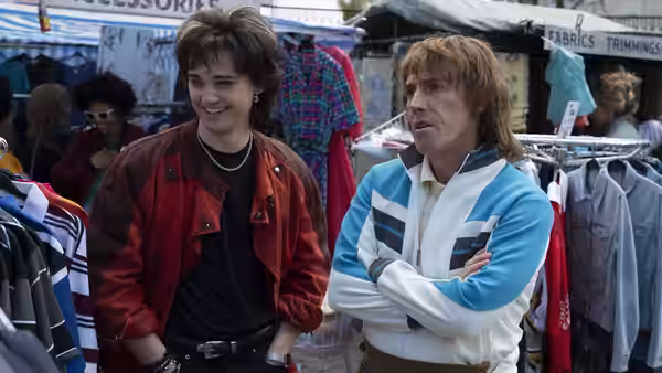 Matt (Dean-Charles Chapman) and Matt’s Dad (Rob Brydon) browse clothes at a market stall
