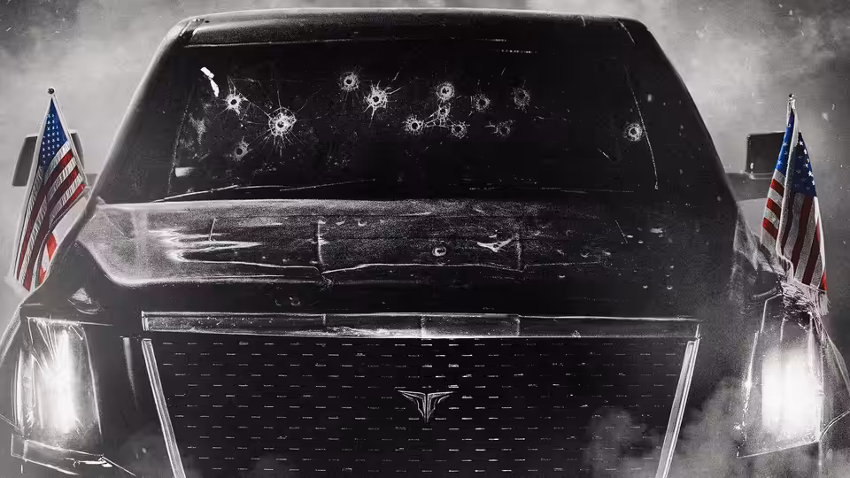 A bullet-riddled presidential limousine bearing American flags