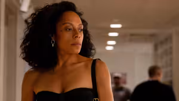 Misty Green (Rosalind Eleazar) pauses in a bright hallway, looking to the side
