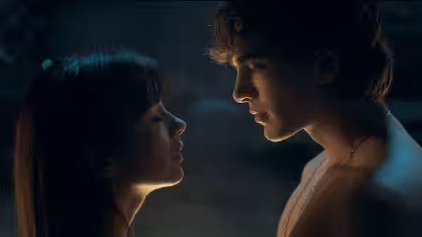 Jude Derry (Irene Balmes) gazes up at a shirtless young man