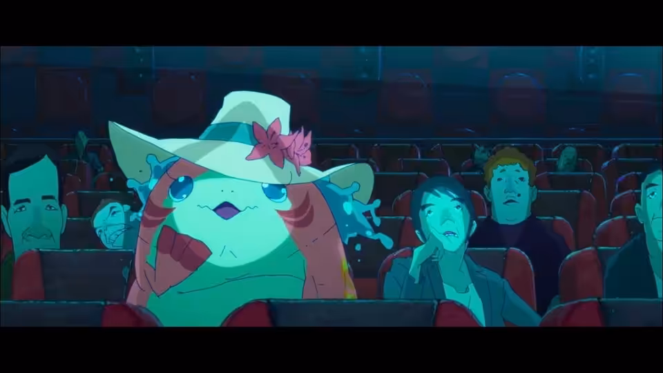 A large sea creature in a flowered hat sits among human spectators in an auditorium
