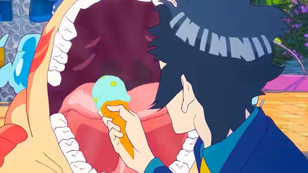 A young man offers a tiny green sea creature food beside a giant open mouth