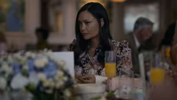 Francesca Carmichael (Thandiwe Newton) sits at a table set for a meal