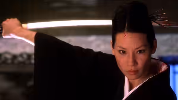 O-Ren Ishii (Lucy Liu) holds sword with blood mark on forehead