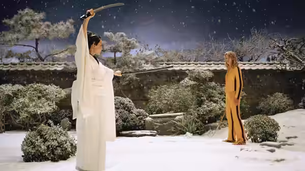 Woman in white robe raises sword in snowy garden facing figure in yellow