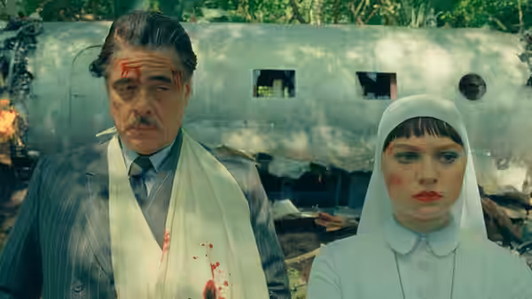 Zsa-zsa Korda (Benicio del Toro) and Sister Liesl standing before a wrecked plane