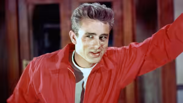 Jim Stark (James Dean) in a red jacket extends his arm outward