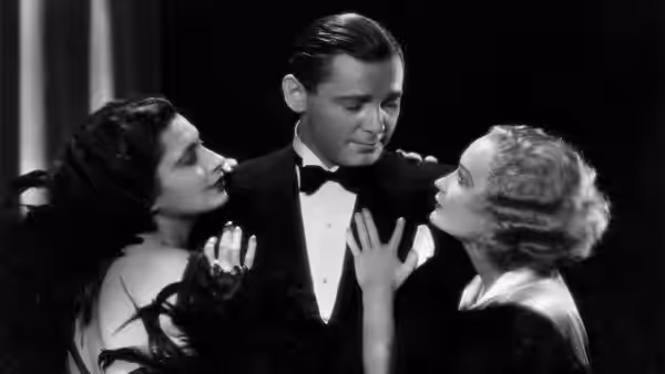 Gaston (Herbert Marshall) stands between Lily and Mariette as they reach toward him