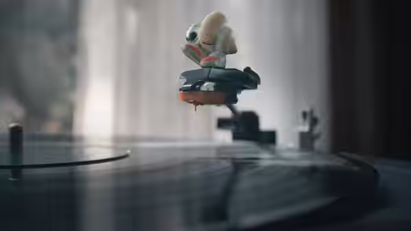 Marcel perched on the tonearm above a spinning record