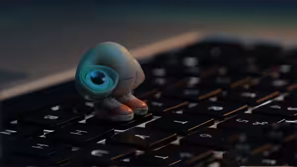 Marcel standing on a computer keyboard with one large eye open