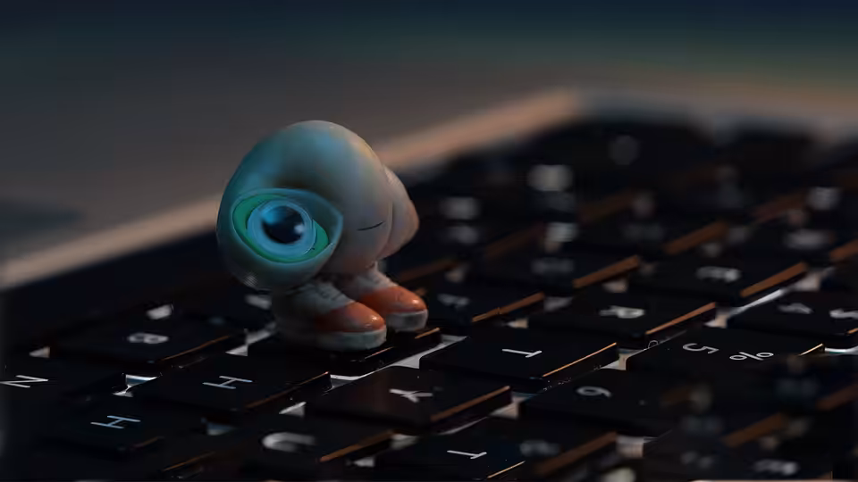 Marcel standing on a computer keyboard with one large eye open