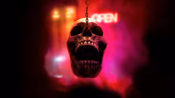 a skull hanging from a chain with its jaw open wide