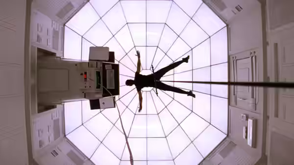 Ethan Hunt (Tom Cruise) dangling from ropes in the center of an octagonal vaulted room