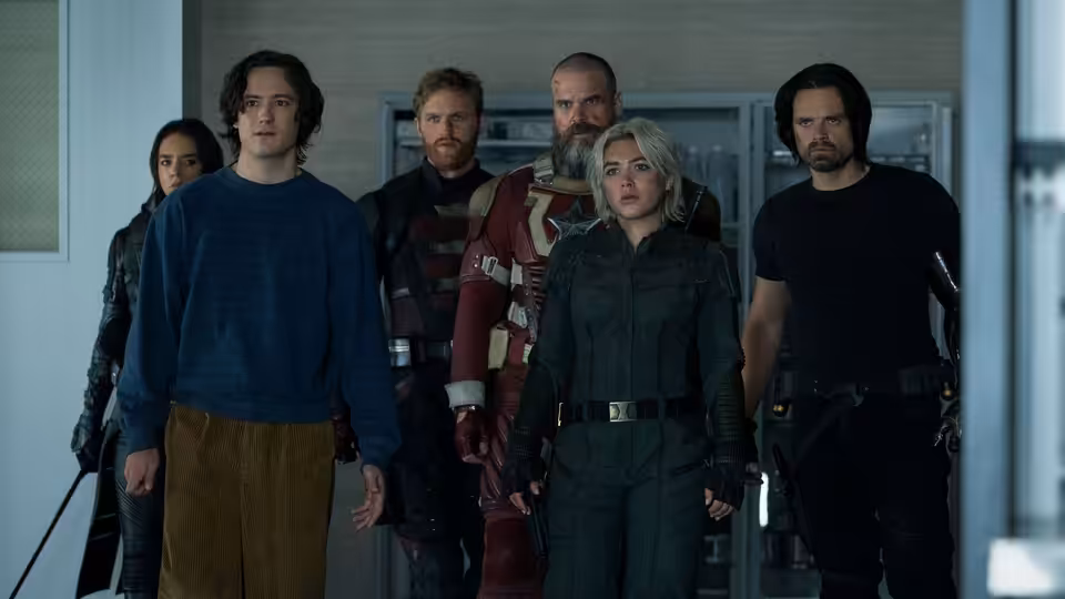 Yelena (Florence Pugh) leading a group of allies down an office corridor