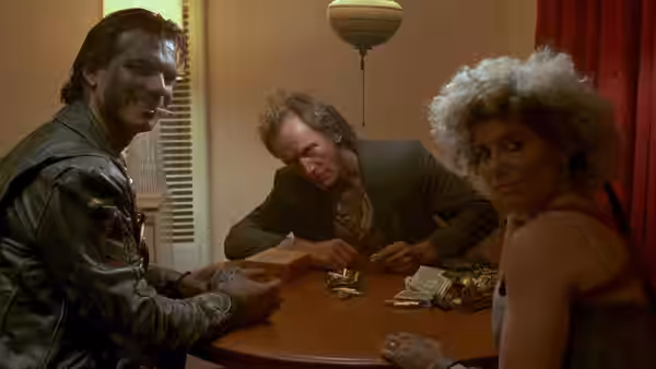 Caleb Colton (Adrian Pasdar), Jesse Hooker (Lance Henriksen) and Diamondback (Jenette Goldstein) gather around a table