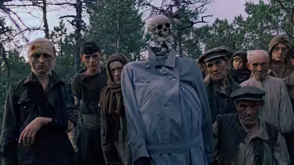 Men standing around a skeleton dressed in a coat in the woods