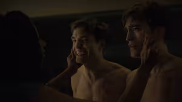 Mickey Barnes (Robert Pattinson) marked 18 beside another marked 17