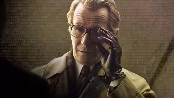 An older man wearing glasses and black gloves adjusting his eyewear with one hand