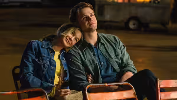 Roxby McDuff (Leo Woodall) and Bridget Jones (Renée Zellweger) on bleachers at night
